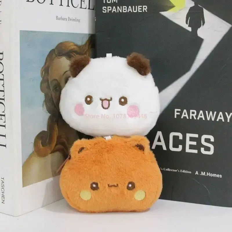 Cute Dudu and Bubu coin wallet plush toys stacked beside books on a shelf, showcasing their playful design.